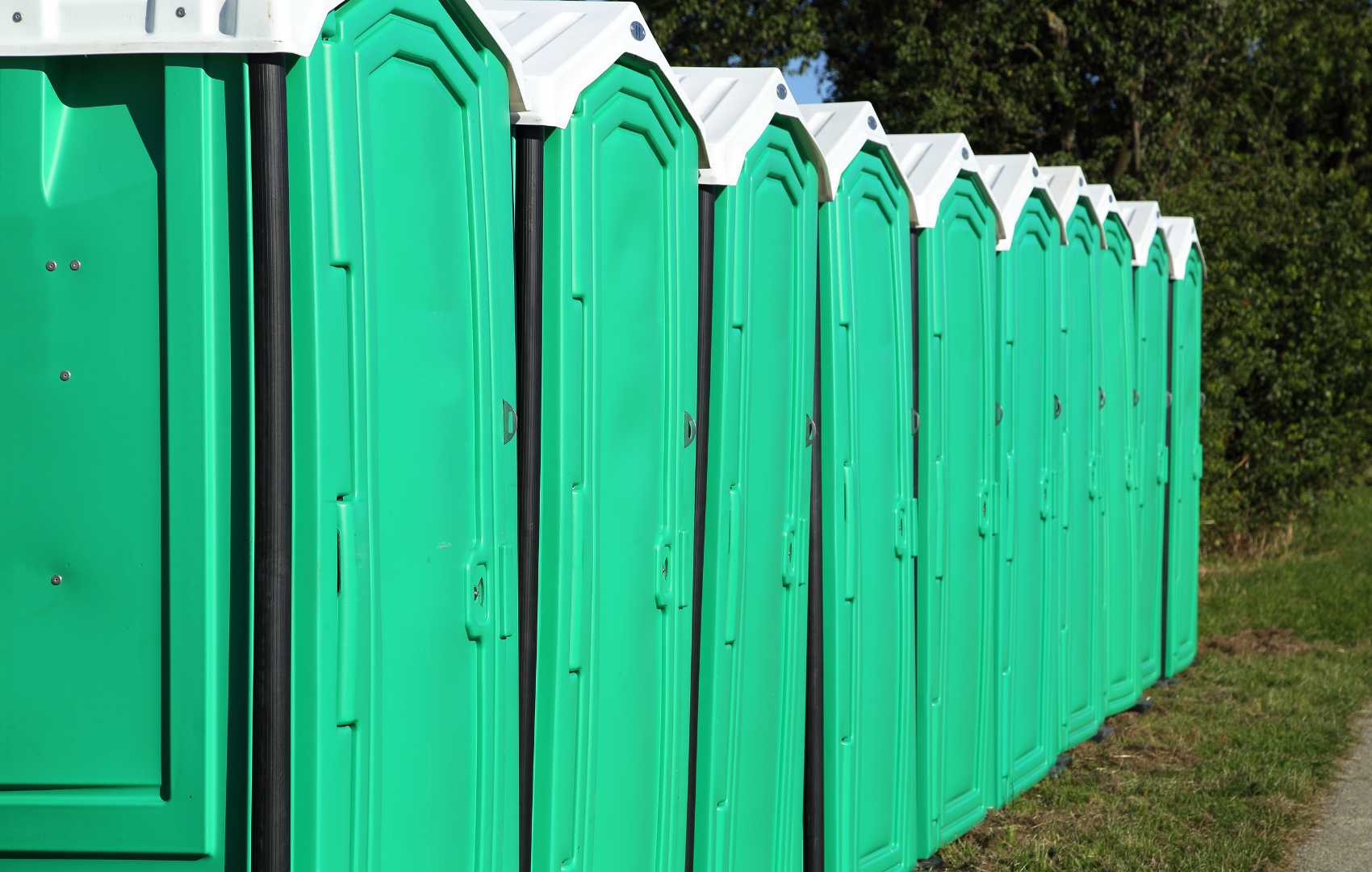 Portable toilets in a row at a site